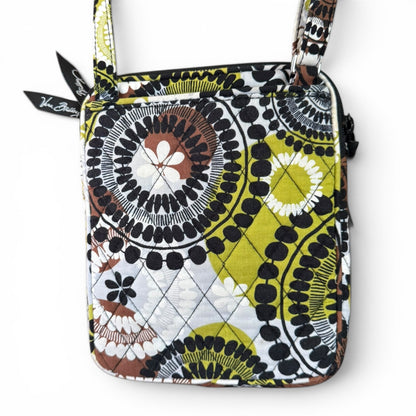 Back of Patterned handbag with a visible brand name on zipper pull on a white background