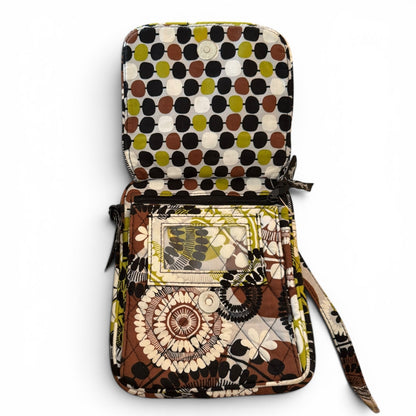 Small crossbody with multicolor print with flap open with a strap on a white background
