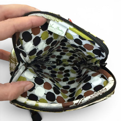 Polka dot fabric inside a small bag with a hand holding it open on a white background