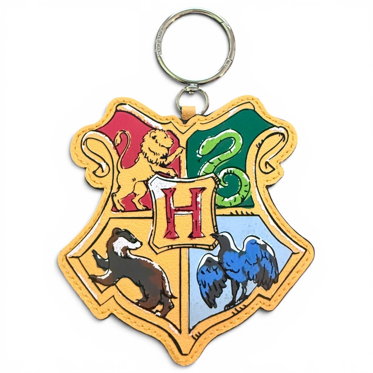 Bag charm with Hogwarts school crest design on a white background