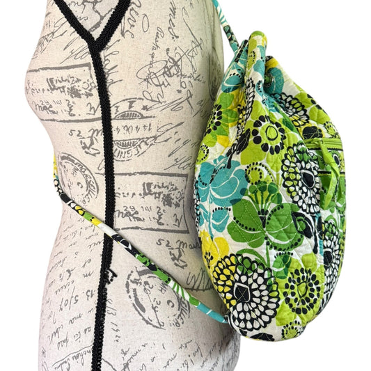 Side view of Colorful floral-patterned bag draped over a mannequin with a script design.