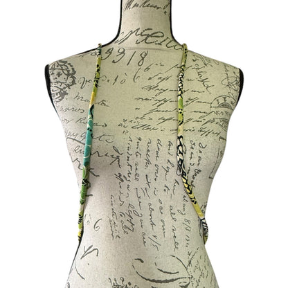 Straps of green floral packback on a background with text and graphics.