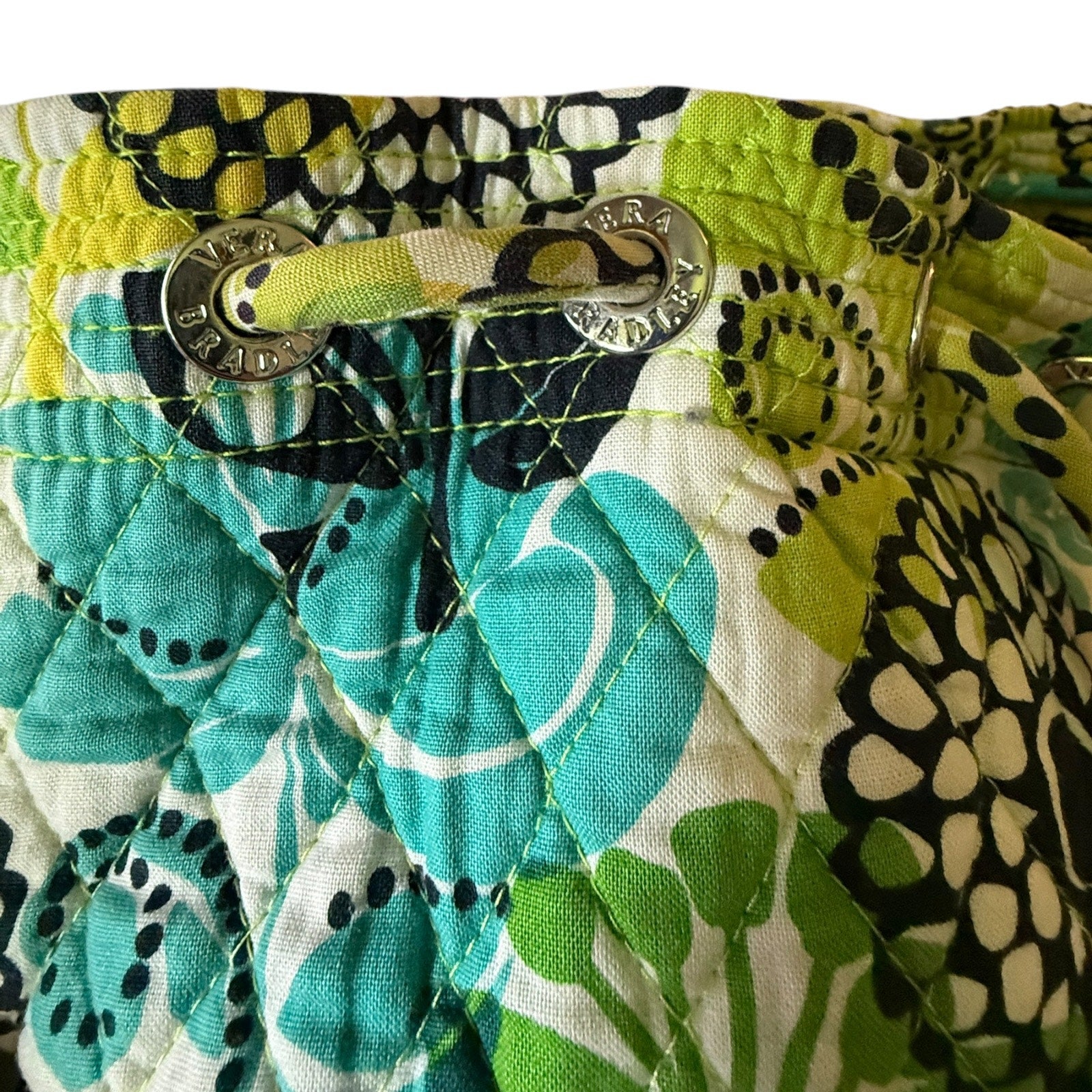 Close-up of a colorful fabric with floral patterns and a metal clasp.