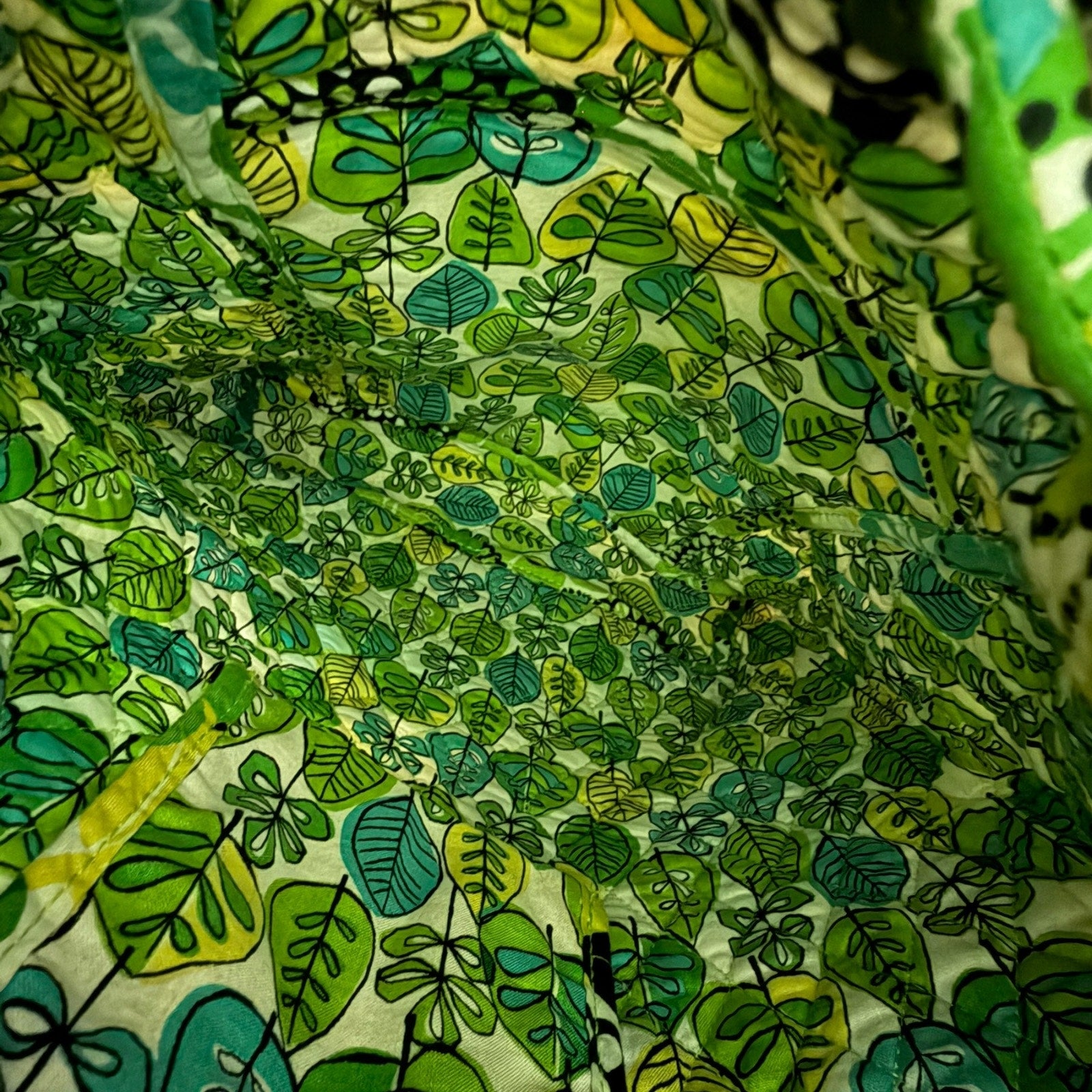 Close-up of green leaf pattern interior of bag