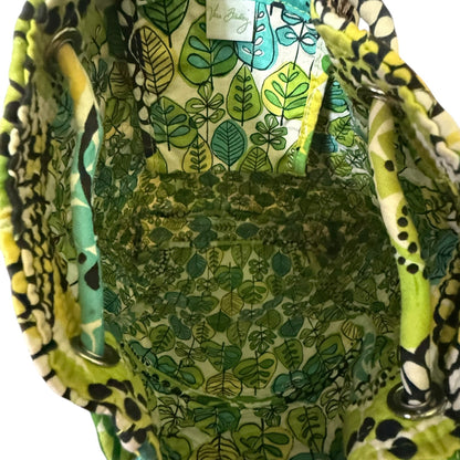 Green leaf-patterned bag interior with colorful handles on a white background