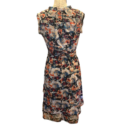 A sleeveless dress with a multicolor abstract painterly print, displayed on a mannequin against a plain white background.
