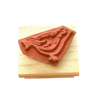 Rubber stamp of a bird on a wooden base with a white background