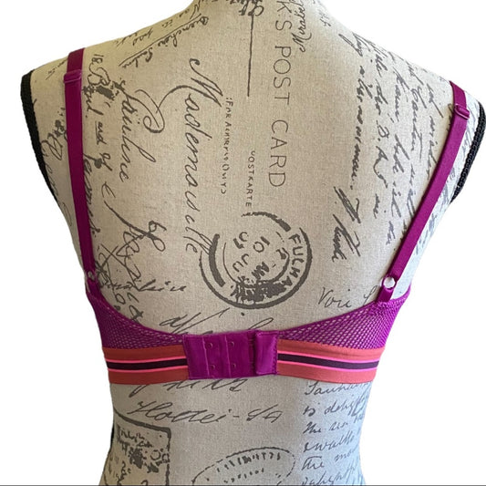 A close-up back of a bra displayed on a fabric mannequin torso. 