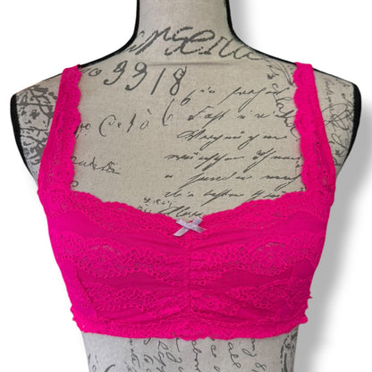 Front of Pink lace bra on a mannequin with a vintage-style background