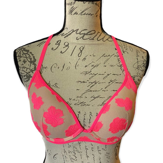 Bra with pink floral design on a mannequin with script text background
