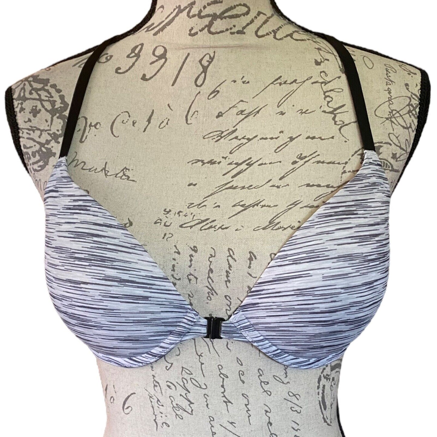 Black & white bra on a mannequin with a vintage letter background
