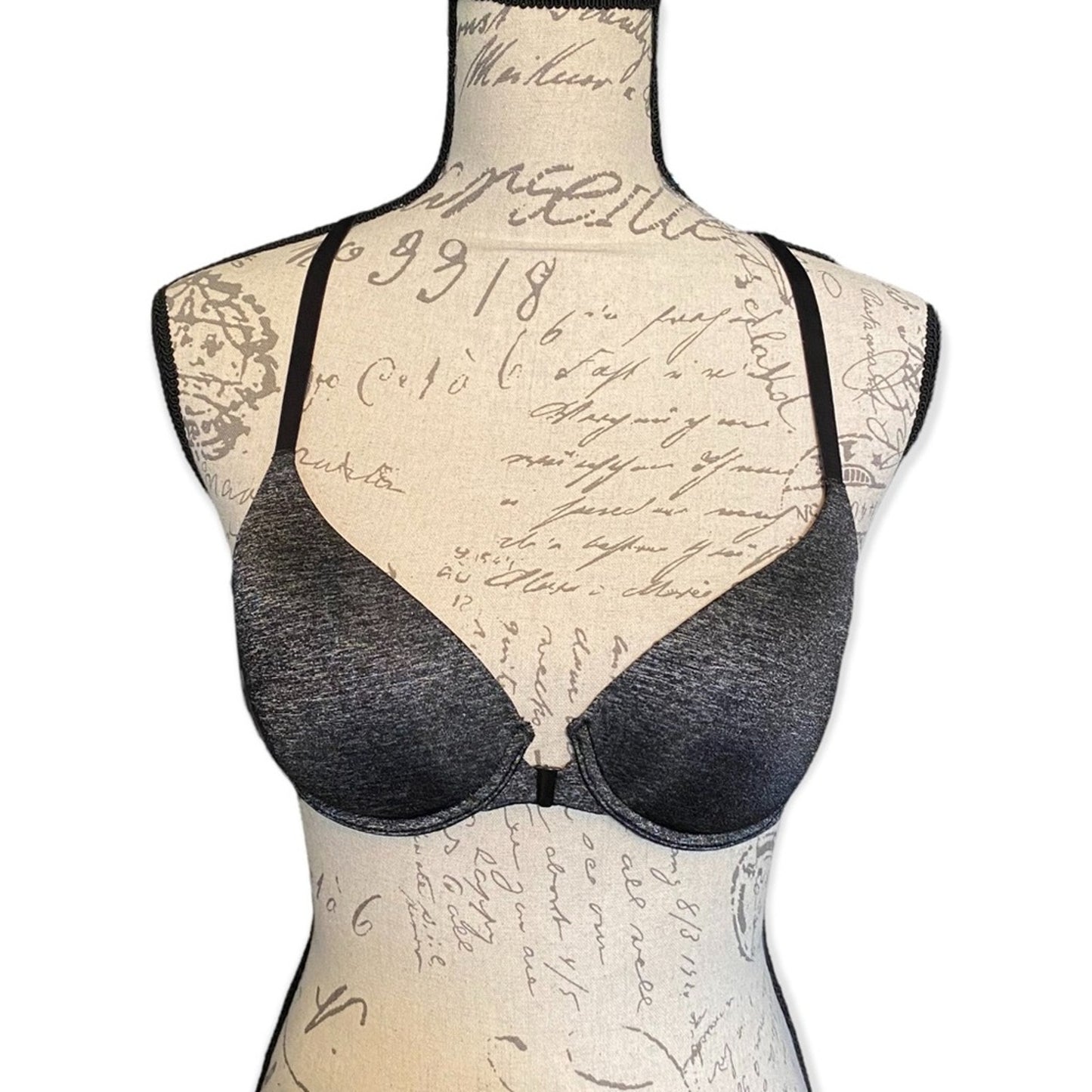 Black bra on a mannequin with a vintage-style script background