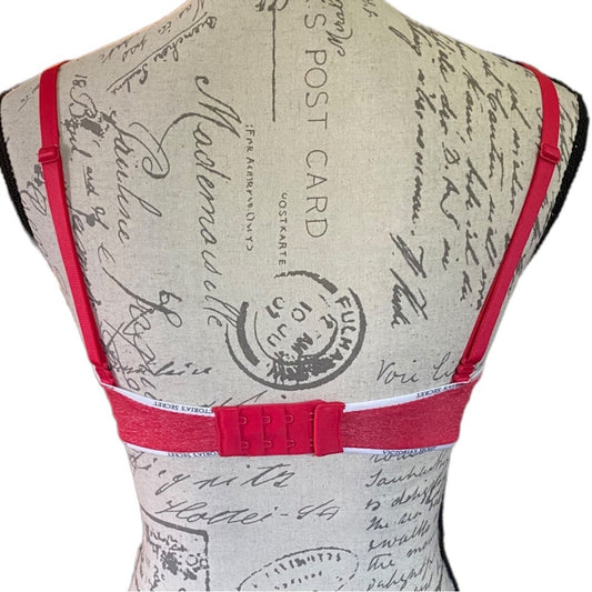 Back of bra with red straps and vintage-style text design on a white background