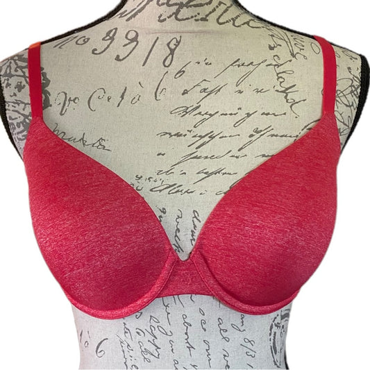 Red bra on a mannequin with a patterned background