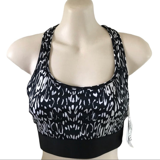 Black sports bra with white pattern on a mannequin against a white background