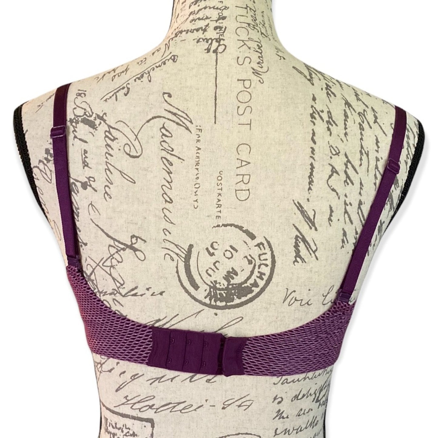 Back of Purple bra on a mannequin with a vintage-style background