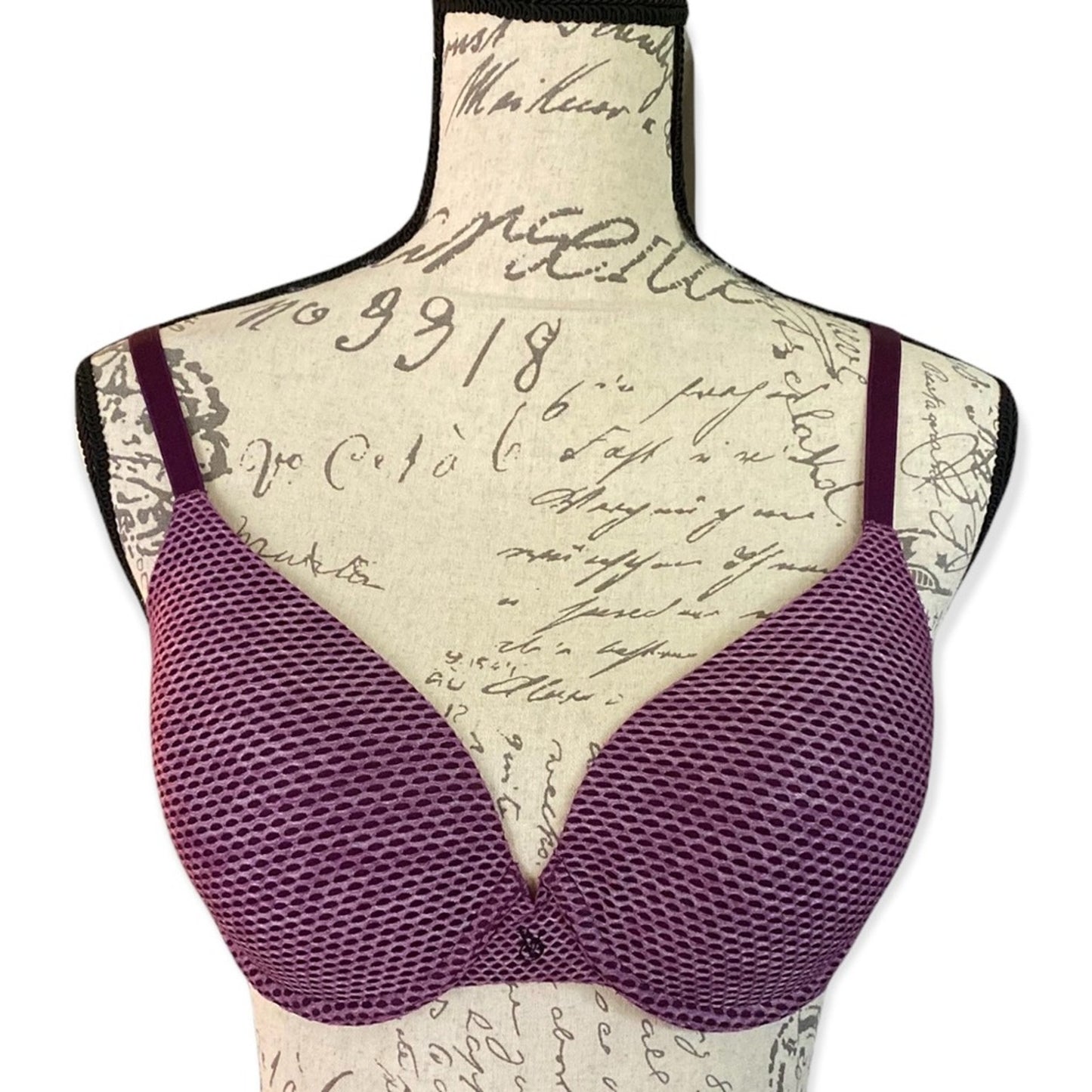 Front of Purple bra on a mannequin with a script patterned background