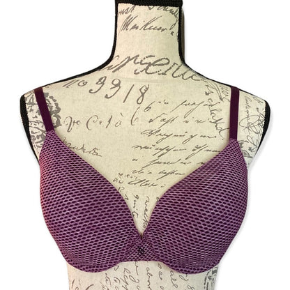 Front of Purple bra on a mannequin with a script patterned background