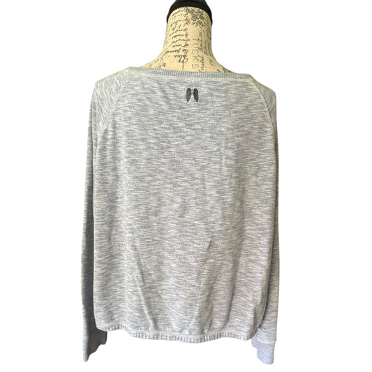 Back of long sleeve shirt on a mannequin with a visible brand logo on the back.