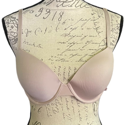 Light pink bra with vintage script pattern on a mannequin