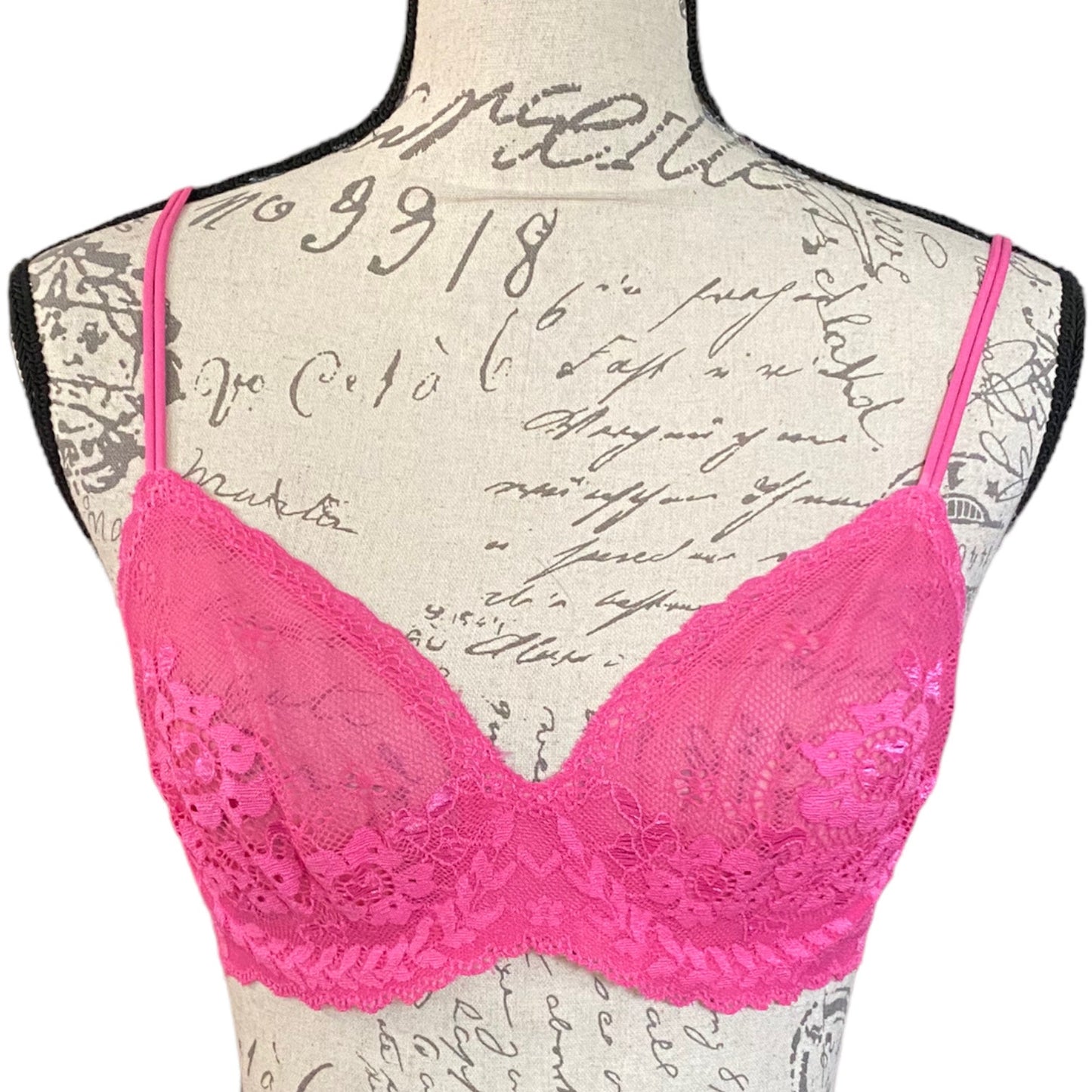 A pink lace bra with underwire and adjustable straps on a mannequin, from the Victoria's Secret Angels collection.