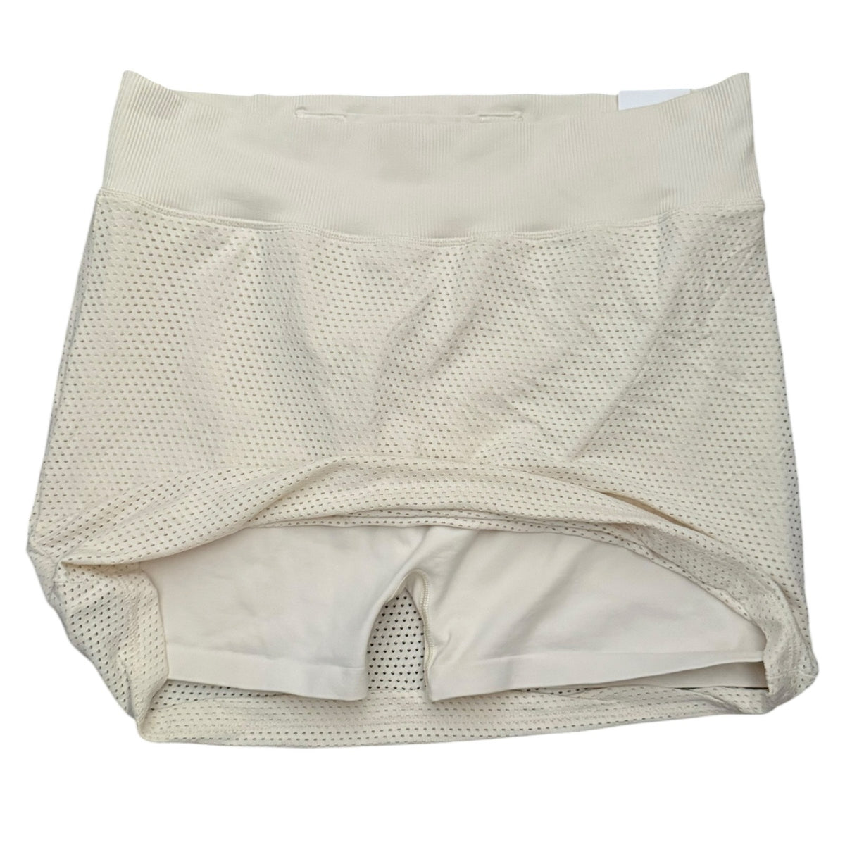 Beige skort showing shorts with a wide waistband, laid flat on a white background.