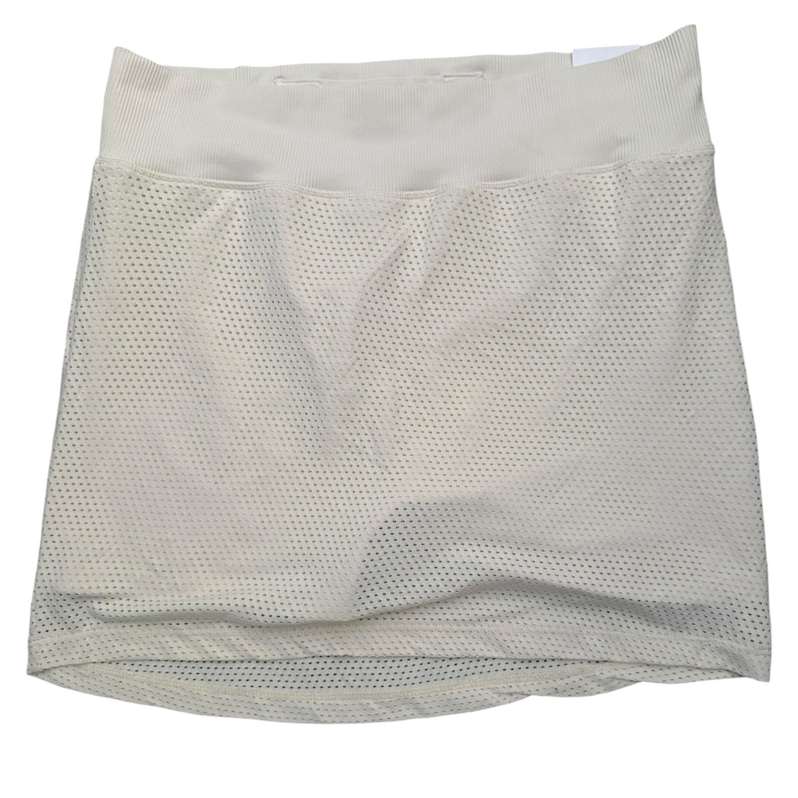 A beige mesh athletic skort with a wide elastic waistband, shown flat against a white background.