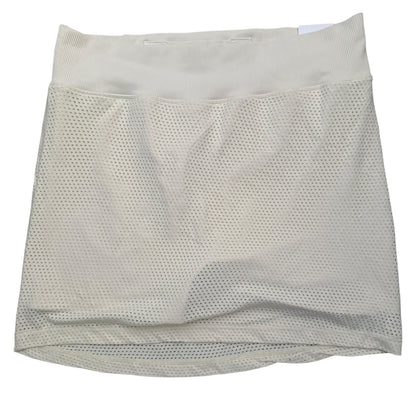 A beige mesh athletic skort with a wide elastic waistband, shown flat against a white background.