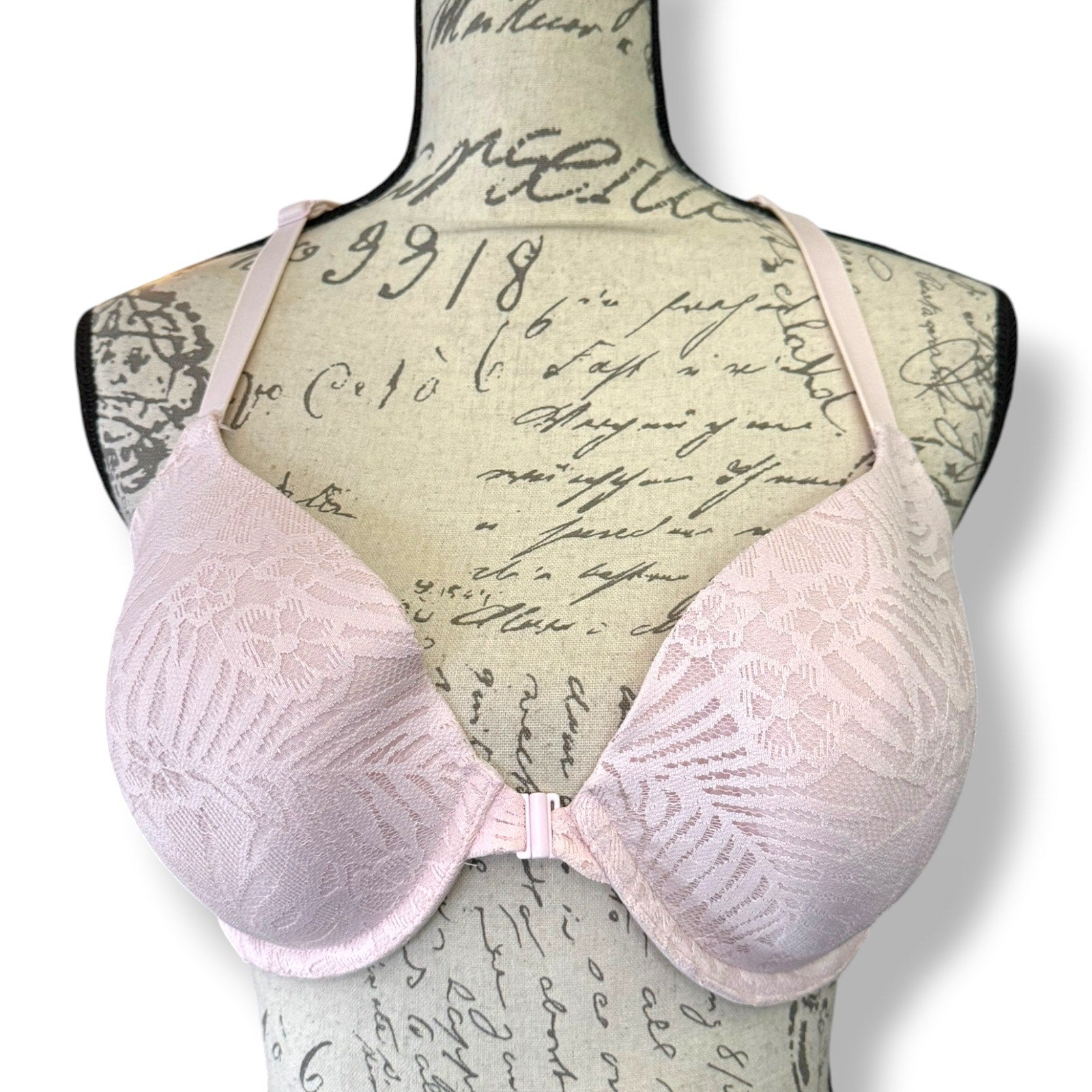 Pink bra on a mannequin with a vintage-style background