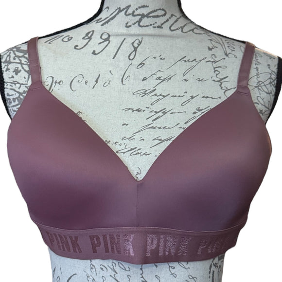 Purple bra with 'PINK' logo on a mannequin with script patterned back