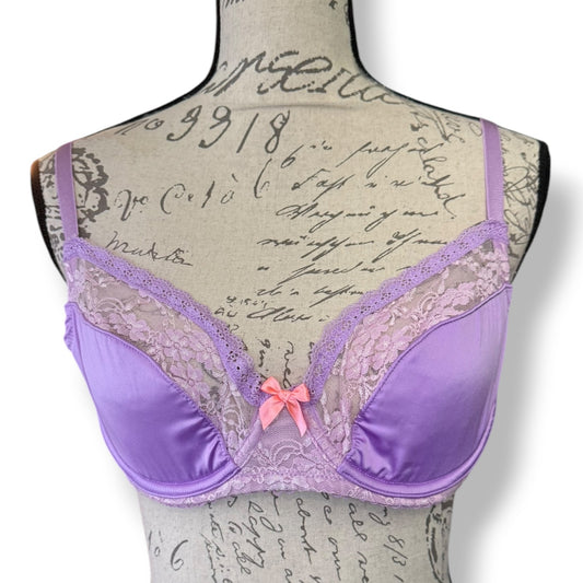 Purple bra with lace detailed bra on a mannequin with script text background