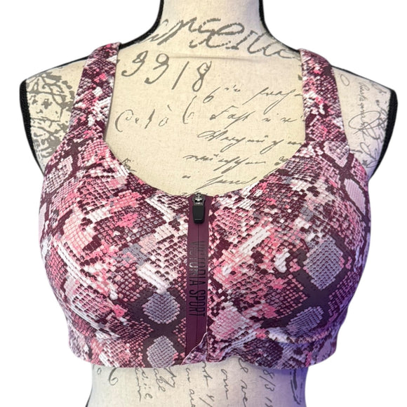 Pink snake patterned sports bra on a mannequin with a white background
