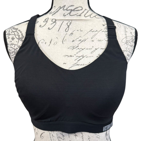 Black sports bra on a mannequin with a script patterned back