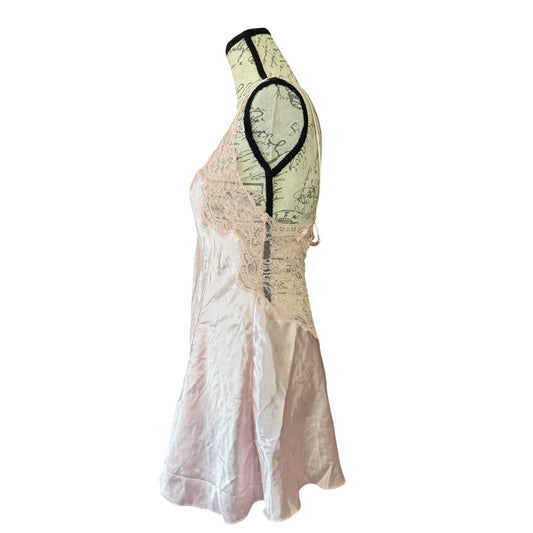 A sleeveless pink satin nightgown with a sheer lace overlay displayed on a dress form against a white background.
