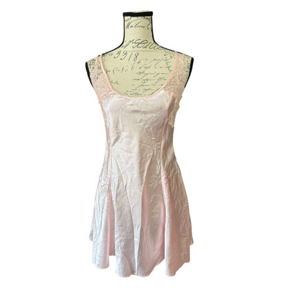 A light pink satin nightgown with lace trim on the neckline, displayed on a vintage-style black dress form mannequin against a white background.