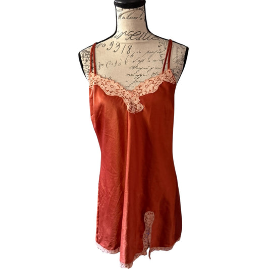 Orange satin nightgown with lace trim on a mannequin against a white background