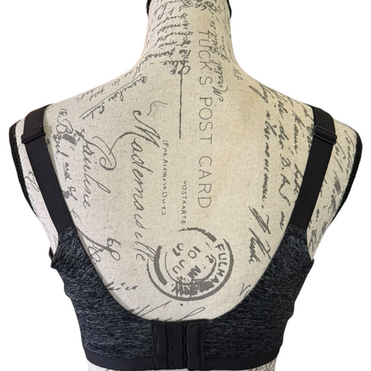 Back view of a black bra displayed on a mannequin torso with a vintage-style beige script print.