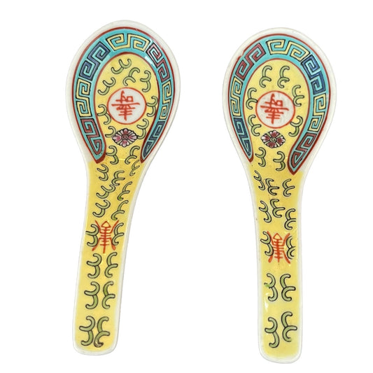 Two decorative spoons with intricate patterns on a white background