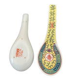 Two ceramic spoons, one plain white and one with colorful decorative patterns on a white background.