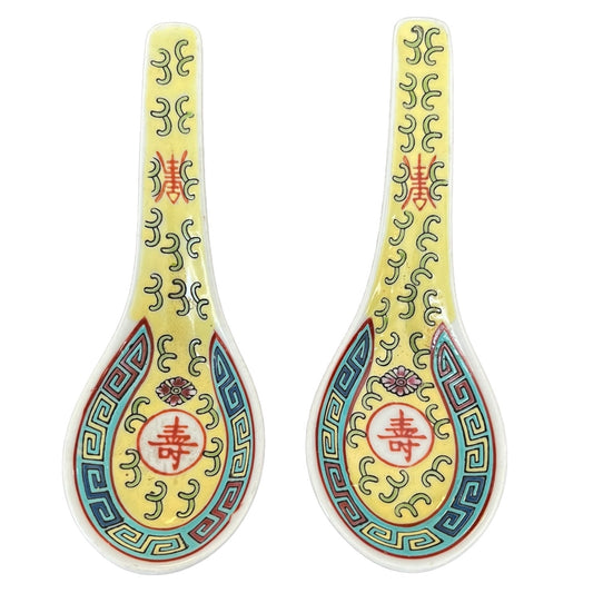 Two decorative spoons with intricate patterns and Chinese characters on a white background
