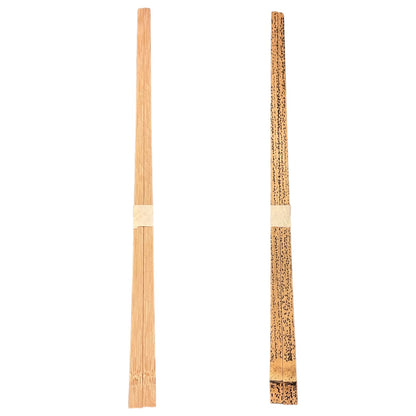 Two wooden chopsticks shown vertically on a plain white background, one plain light wood and one with a dark textured pattern and a light band near the top.