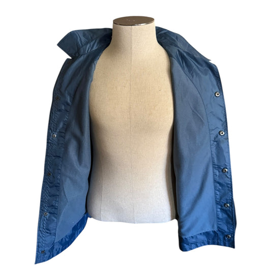 Blue jacket on a mannequin against a white background