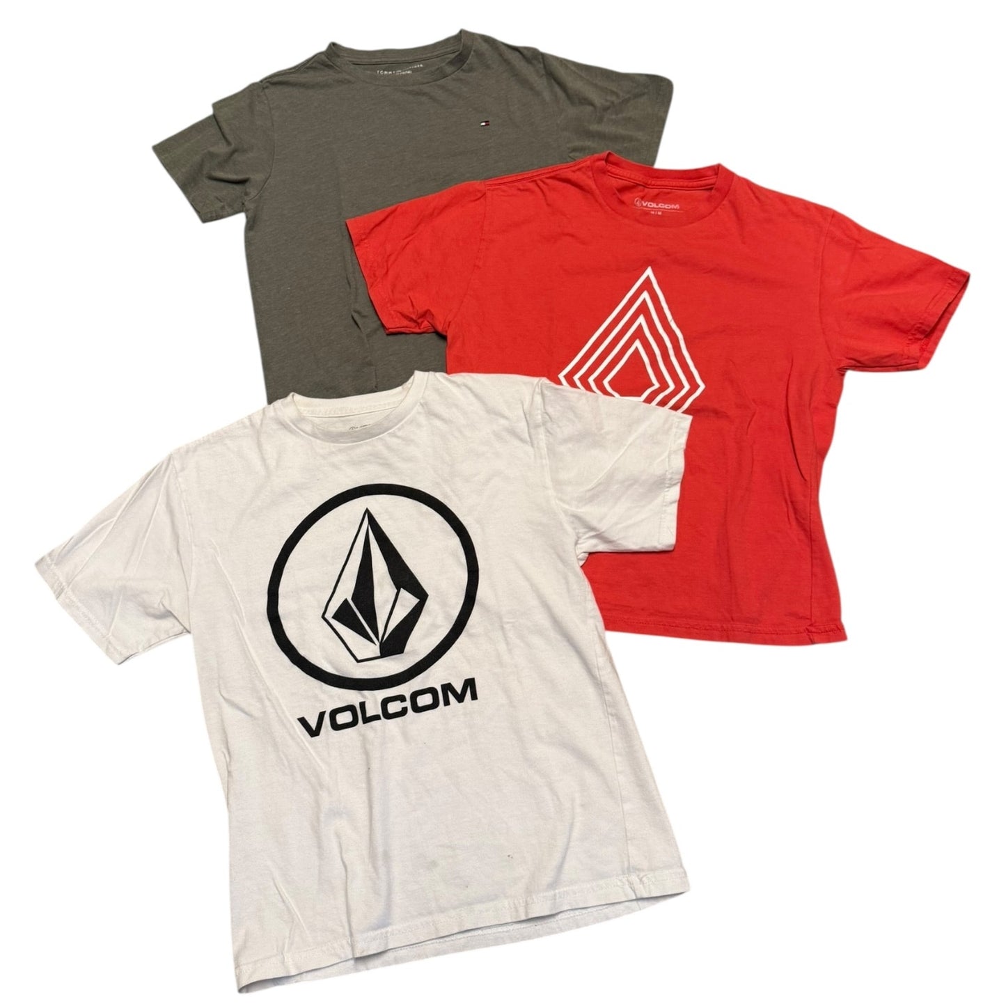 Three t-shirts in gray, red, and white with Volcom logo on a white background