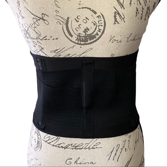 Black waist support belt on a mannequin with a vintage-style background