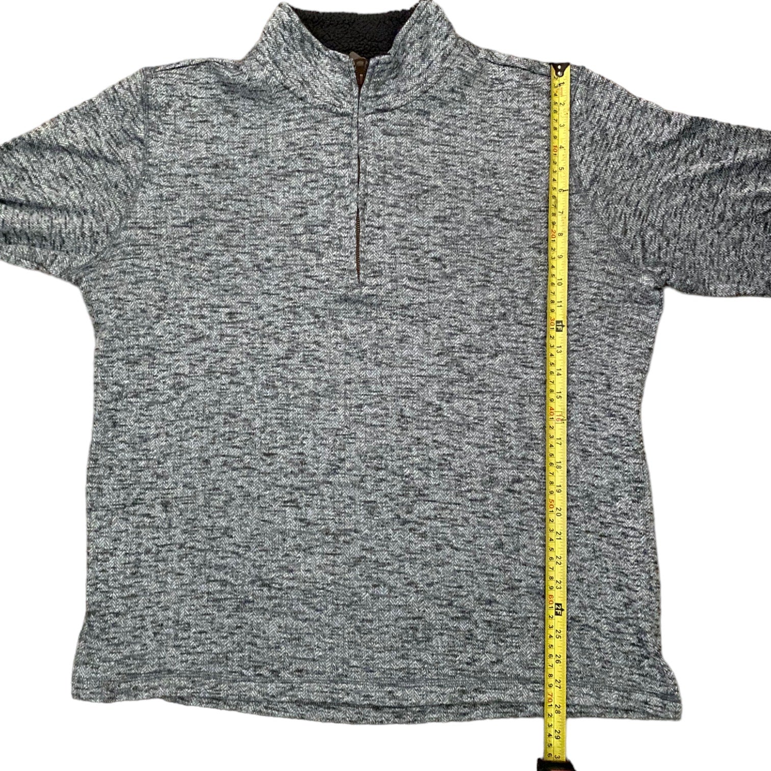 Gray sweater with a measuring tape on a white background