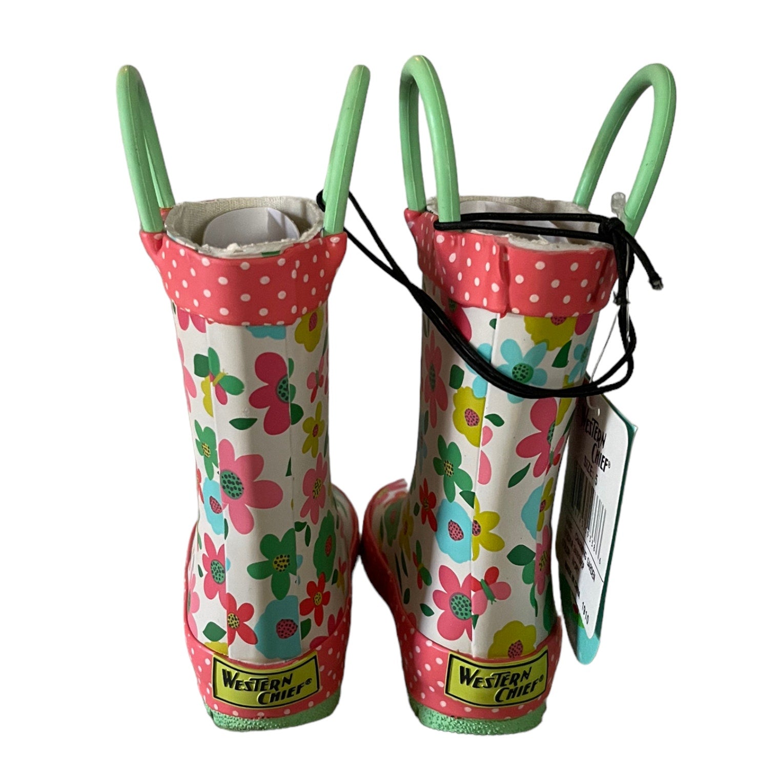 Pair of children's floral rain boots with pink polka dot trim on a white background