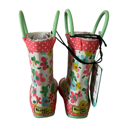 Pair of children's floral rain boots with pink polka dot trim on a white background