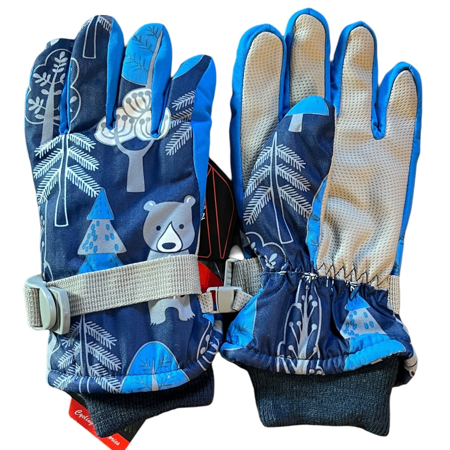 Pair of blue children's gloves with bear and tree design on a white background