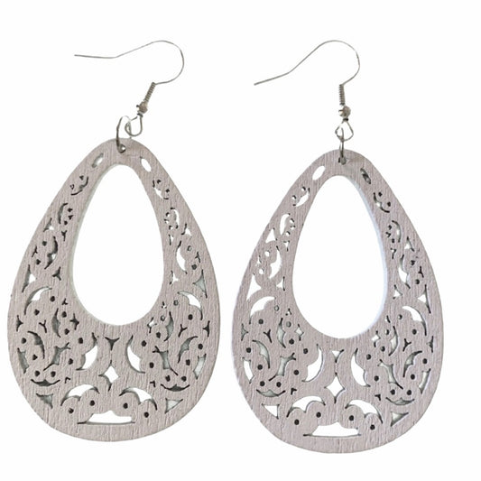 A pair of white teardrop-shaped dangle earrings with intricate filigree cutouts and fishhook wires, displayed against a solid white background.