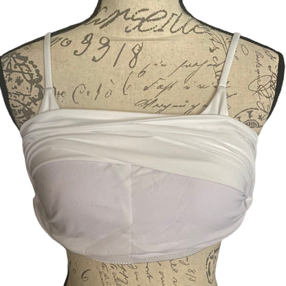 White front of built in bra on a mannequin with an old document background